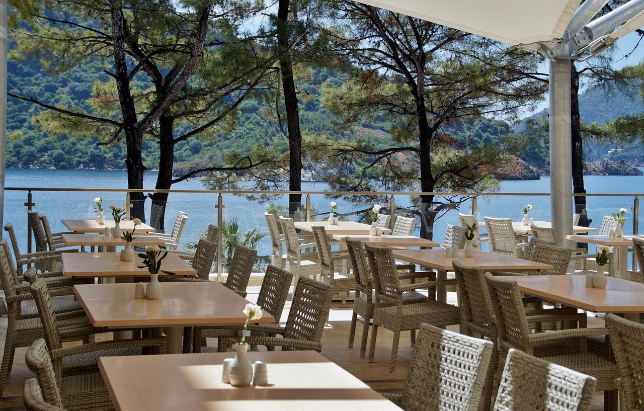 Garden terrace of the pizzeria with flowers and tables